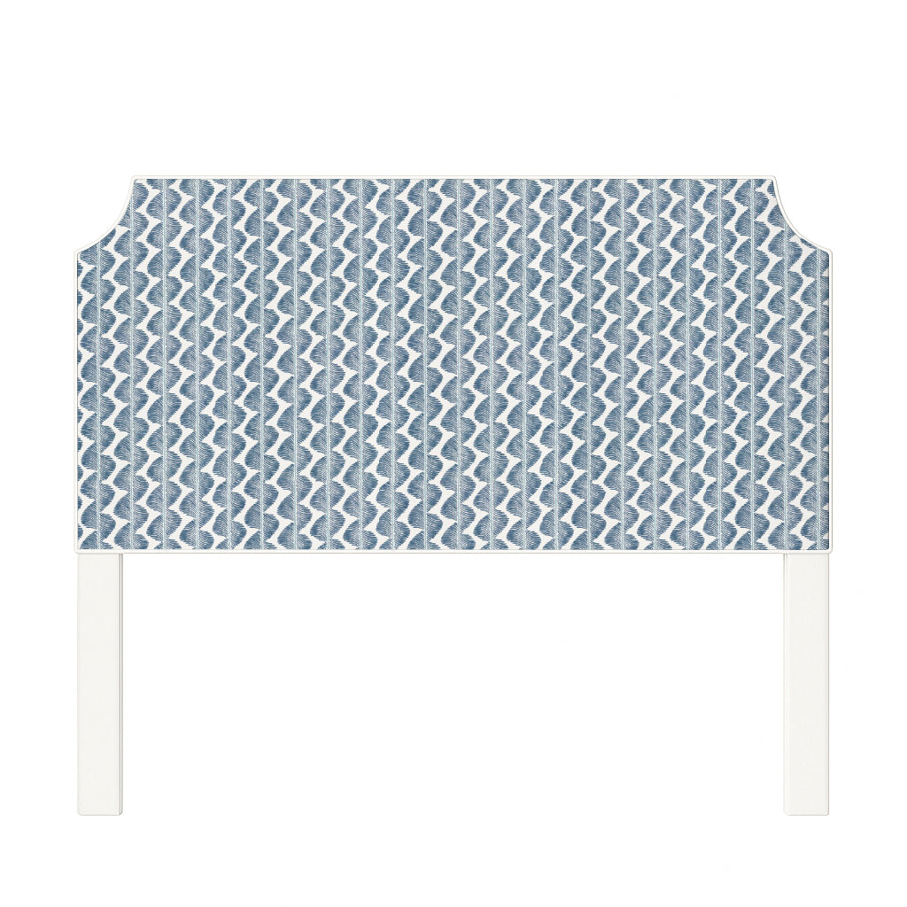 Charlotte upholstered headboard in Fabric&Frame Buxton Blue, shown on a white bed base in a modern bedroom.