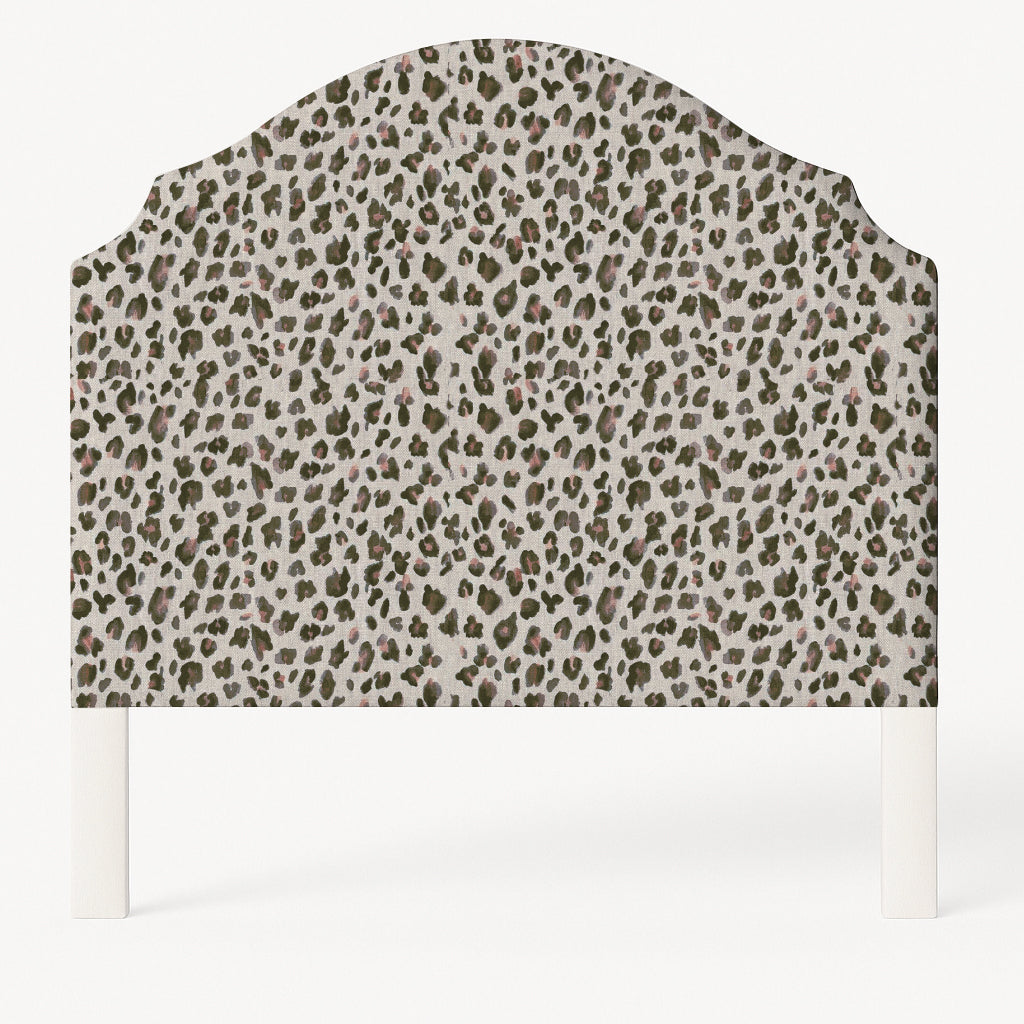 Grace upholstered headboard in Fabric&Frame Spinach on Pink, shown on a white bed base in a modern bedroom.