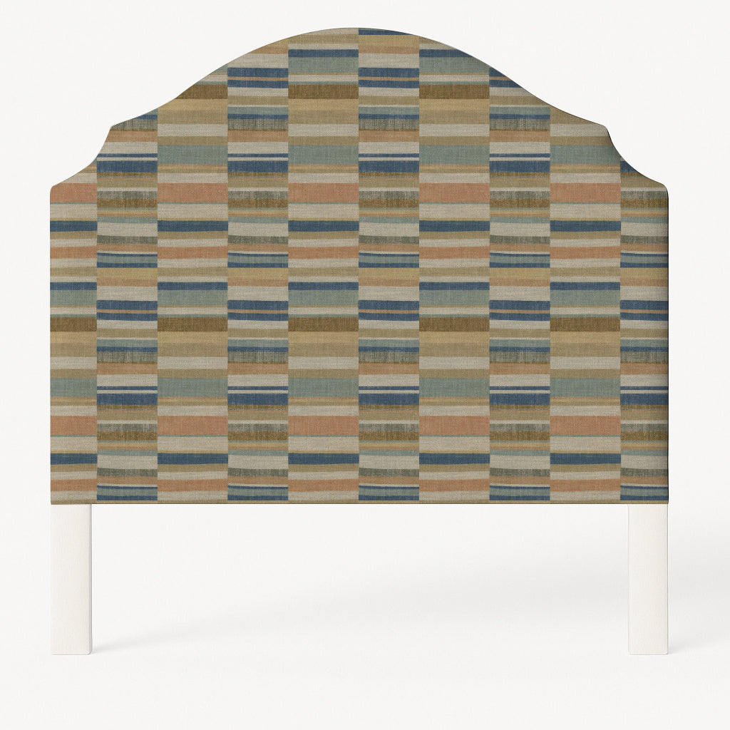 Grace upholstered headboard in Fabric&Frame Rhubarb, shown on a white bed base in a modern bedroom.