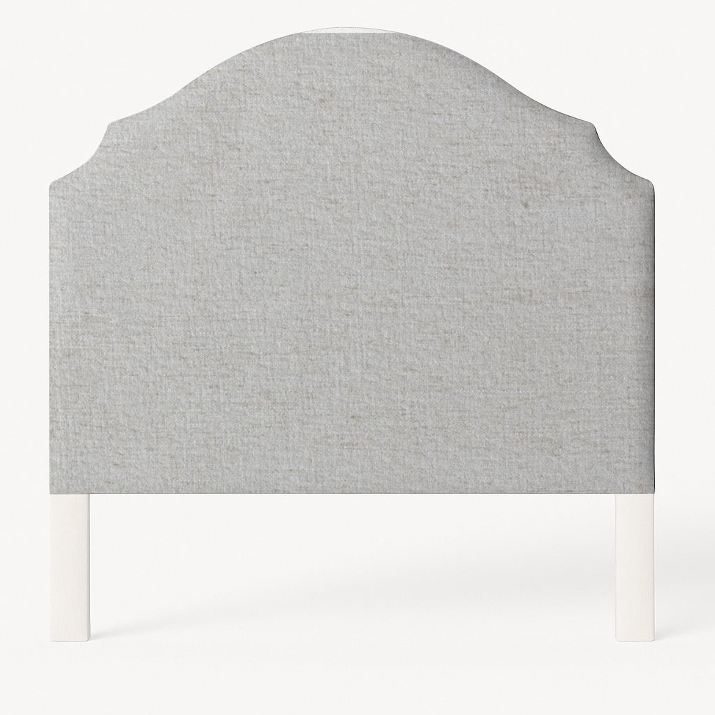 Grace upholstered headboard in Fabric&Frame Santorini, shown on a white bed base in a modern bedroom.