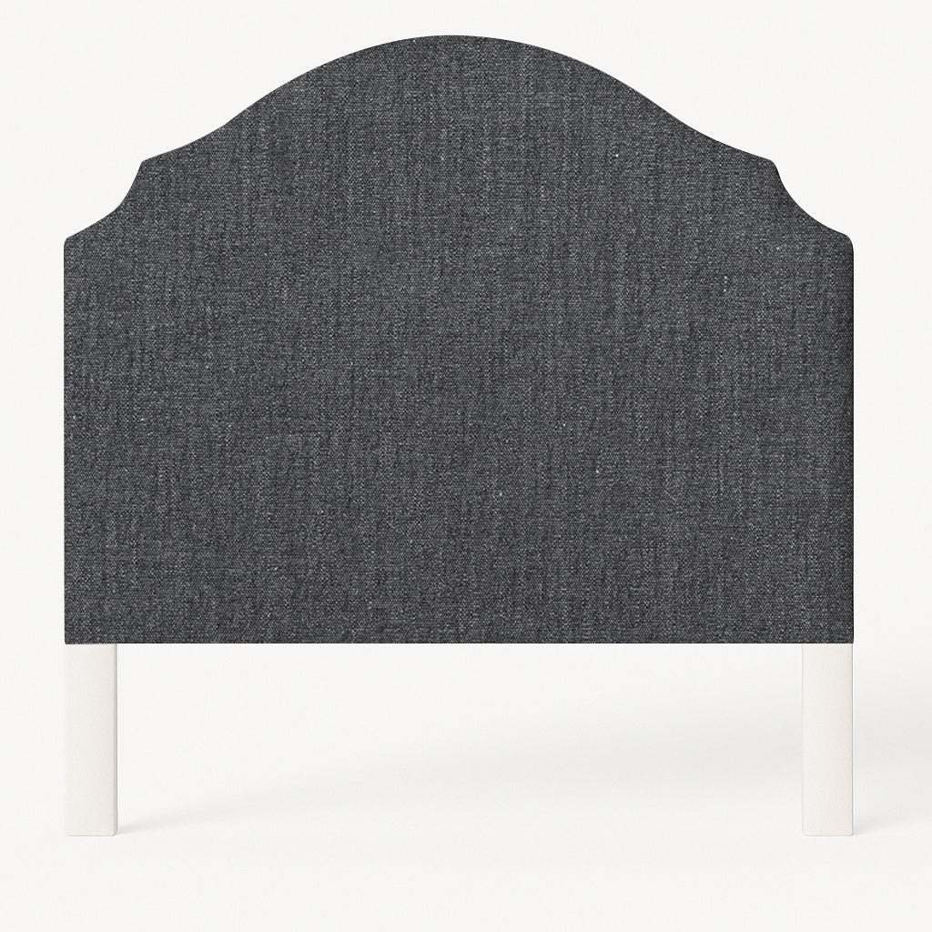 Grace upholstered headboard in Fabric&Frame Santorini, shown on a white bed base in a modern bedroom.