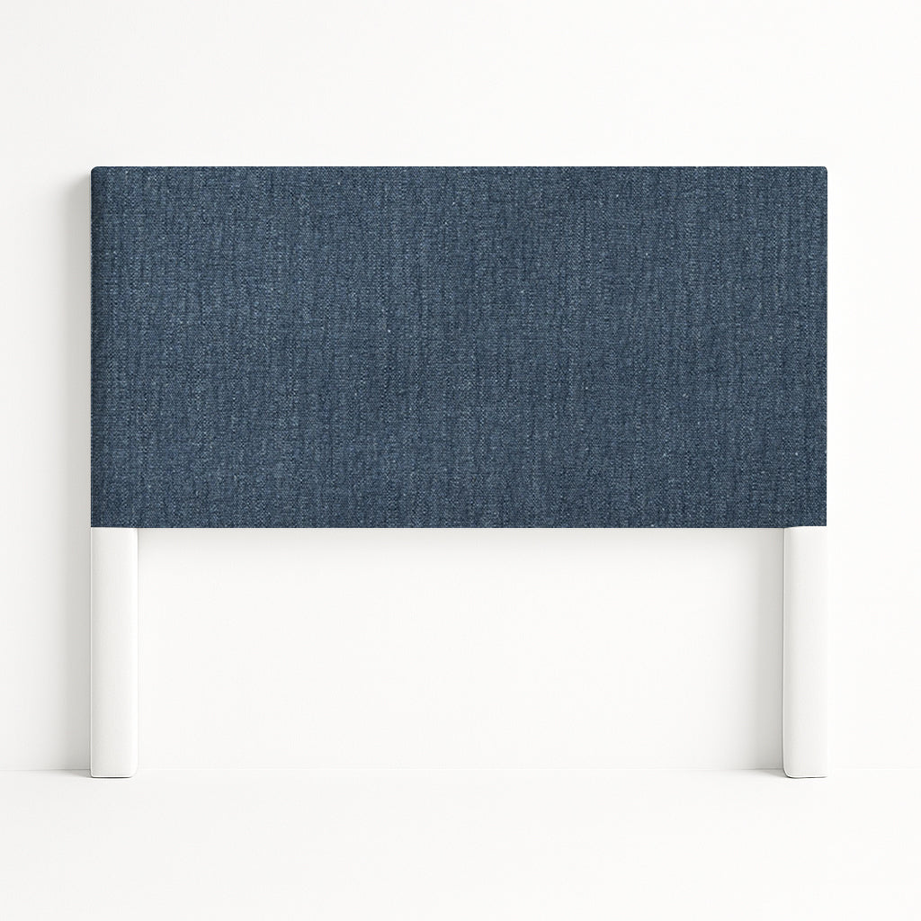 Iris upholstered headboard in Fabric&Frame Santorini, shown on a white bed base in a modern bedroom.