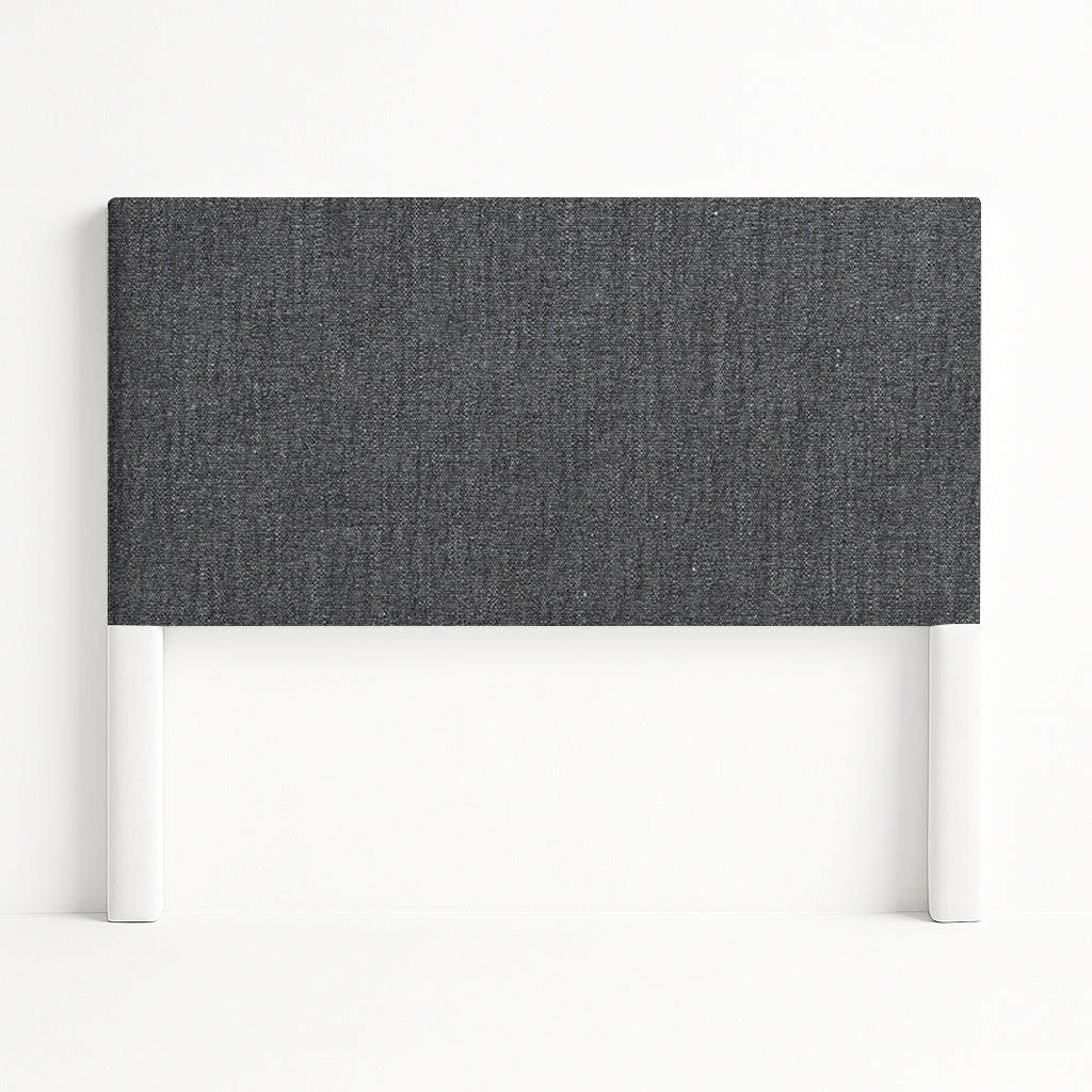 Iris upholstered headboard in Fabric&Frame Santorini, shown on a white bed base in a modern bedroom.