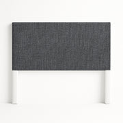 Iris upholstered headboard in Fabric&Frame Santorini, shown on a white bed base in a modern bedroom.