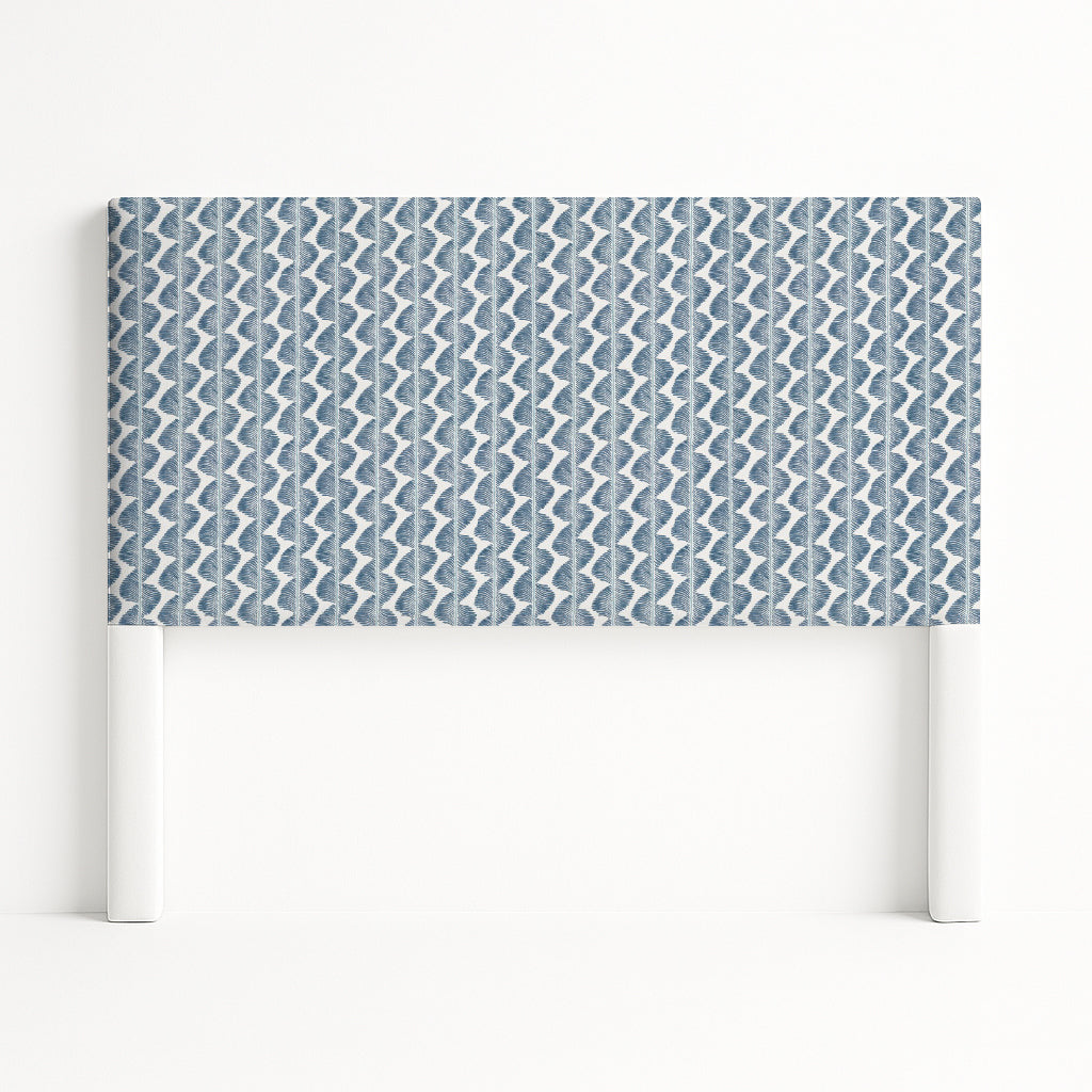 Iris upholstered headboard in Fabric&Frame Buxton Blue, shown on a white bed base in a modern bedroom.